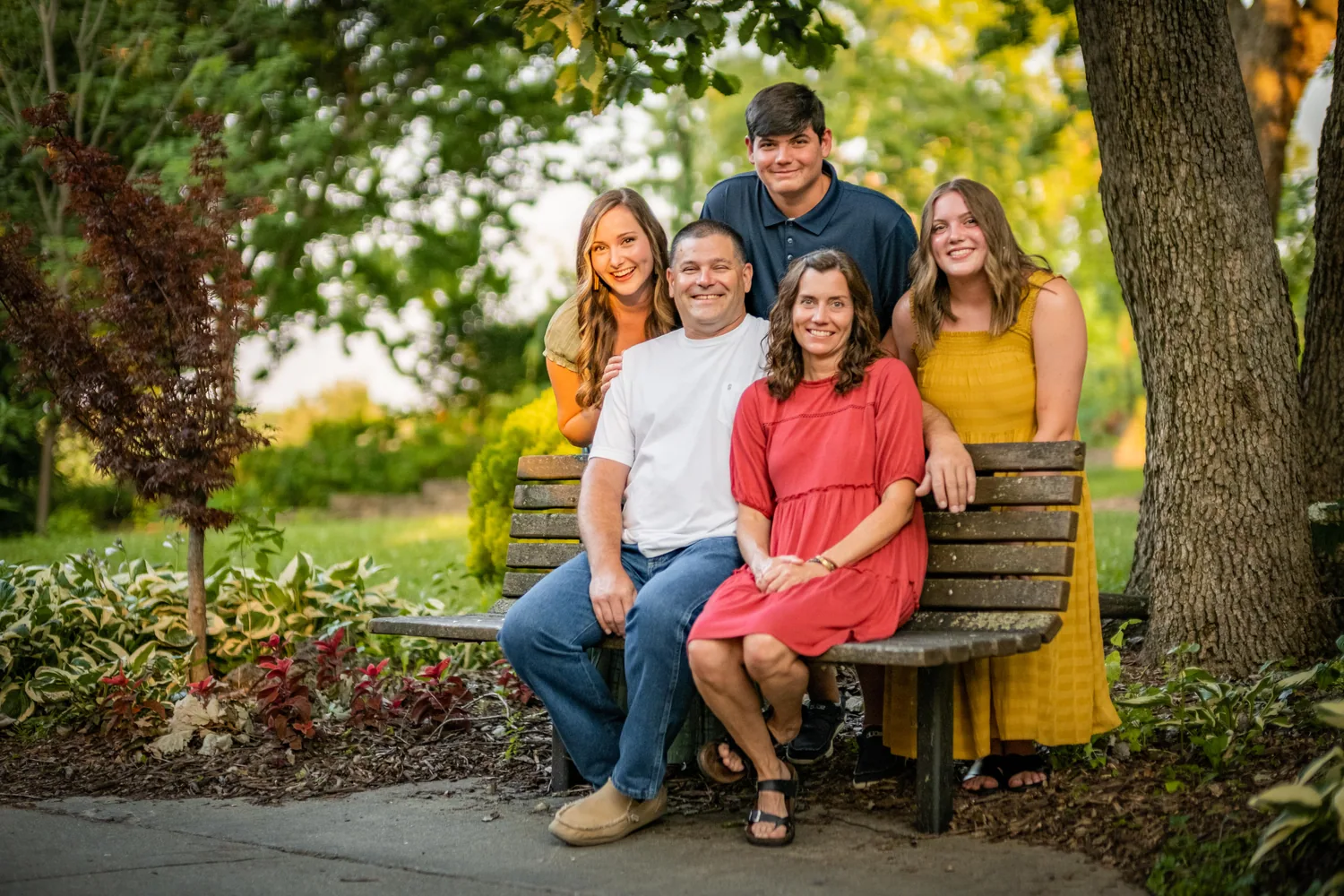Family of five on a park bench