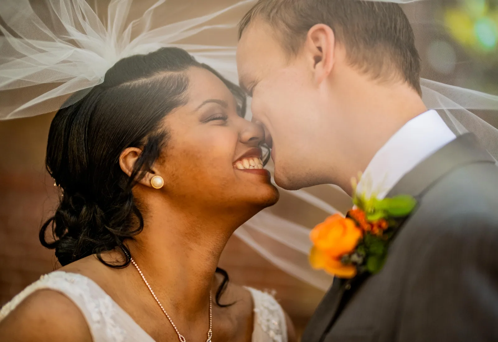 A close wedding moment under a veil